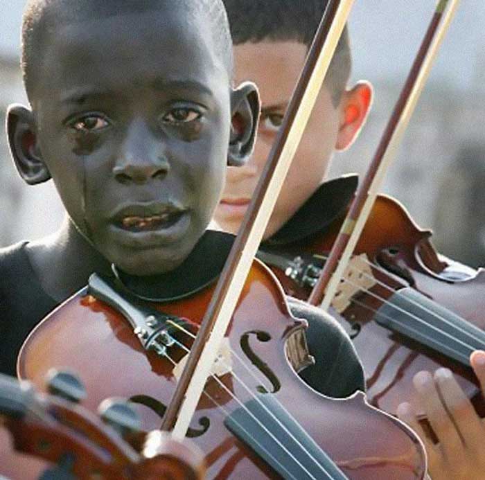 26. Diego Frazão Torquato, 12 year old Brazilian playing the violin at his teacher’s funeral.